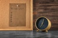 Alarm clock on table and sheet of paper with to-do list on board. Time management concept Royalty Free Stock Photo