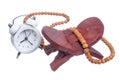 Alarm clock and Tasbih or Islamic prayer beads on rehal