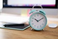 Alarm clock for ten in morning is on desktop in office Royalty Free Stock Photo