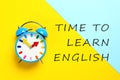 Alarm clock and text Time To Learn English on background Royalty Free Stock Photo