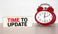 Alarm clock and text Time to Update. Time to Update concept Royalty Free Stock Photo