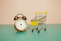Alarm clock with trolley shopping cart, Business concept, Shopping concept, purchasing time bacgroundk Royalty Free Stock Photo