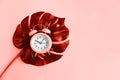 Alarm clock and tropical palm leaf toned coral color with copy space