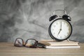 Alarm clock on wood table with school supplies , back to school