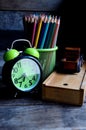 Wooden school pencil case, alarm clock, color pencils, wooden typewriter on an old wooden table. Royalty Free Stock Photo