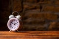 Alarm clock on wooden table on dark background. Place for text Royalty Free Stock Photo