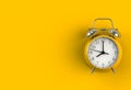 Alarm clock on yellow background