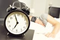 Alarm clock and young man sleeping in bed with a sleep mask Royalty Free Stock Photo