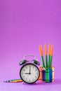 Alarm set at 9 o`clock, colorful cactus, rainbow pencils, working school drawing concept Royalty Free Stock Photo