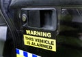 Alarm sign as warning on police vehicle.