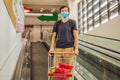 Alarmed man wears medical mask against coronavirus while grocery shopping in supermarket or store- health, safety and Royalty Free Stock Photo