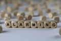 Alarming - cube with letters, sign with wooden cubes Royalty Free Stock Photo