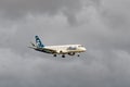 Alaska Airlines Embraer ERJ 170-200 jet on final stormy weather approach