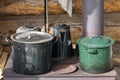 Alaska. Close up of pots and pans in an old iron cooking stove placed in the outside of a cabin. Royalty Free Stock Photo