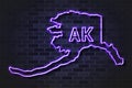 Alaska map glowing neon lamp or glass tube on a black brick wall Royalty Free Stock Photo