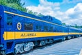 Alaska Rail Road blue and yellow train . Seward , Alaska , USA 08.08.2021