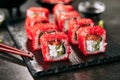 Alaska salmon uramaki sushi restaurant menu with rice, cream cheese, salmon, cucumber, flying fish caviar and nori close up. Macro Royalty Free Stock Photo