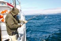 Alaska - Senior Man Fishing Reeling in Halibut Royalty Free Stock Photo