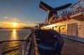 Alaska, USA - June 22 , 2018: Carnival Legend sailing at sunset in one of the Alaskan Fjords. Sun setting down and mountains in Royalty Free Stock Photo