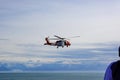 A U.S. Coast Guard helicopter performing a medical evacuation for a cruise ship passenger