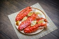 Alaskan king crab legs cooked seafood with lemon spices on wood plate in the table - red crab hokkaido Royalty Free Stock Photo