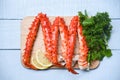 Alaskan King Crab Legs Cooked on wooden cutting board with lemon parsley - red crab hokkaido seafood served table Royalty Free Stock Photo