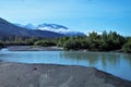 Alaskan landscape with river and snow capped mountains and trees Royalty Free Stock Photo