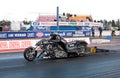 A drag race bike speeding up in quarter mile race with nitro burning