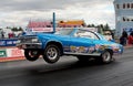 A drag race car speeding up in quarter mile race with nitro burning Royalty Free Stock Photo