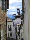 Albaicin, Old muslim quarter, district of Granada in Spain. Narrow street with white houses. Blue summer sky.