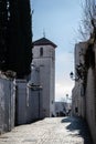 Albaicin street with the tower of the church of San Nicolas in the background