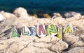 Albania country name made of painted stones on sea background