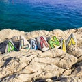 Albania country name on stones, scenery with the sea in the background