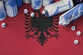 Albania flag and few used aerosol spray cans for graffiti painting. Street art culture concept