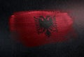 Albania Flag Made of Metallic Brush Paint on Grunge Dark Wall