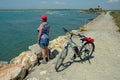 Albarese,Grosseto,Italia - July 29,2021 - Woman with bicycle looking at the sea
