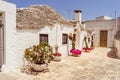 Alberobello, Italy - May 31, 2018 - One of the oldest houses in the city with colored flowers near the front door Royalty Free Stock Photo