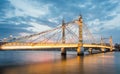 Albert Bridge and beautiful sunset over the Thames, London England UK