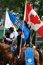 Albertan and Canadian flags flown during a parade