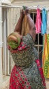African housekeeper hanging laundry on a clothesline