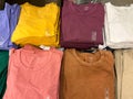 Display of folded plain colorful t-shirts for sale at a Gap outlet store