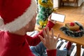 Albino african american man wearing santa hat making video call on smarphone with copy space Royalty Free Stock Photo