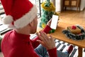 Albino african american man wearing santa hat making video call on smarphone with copy space Royalty Free Stock Photo