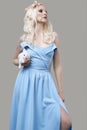 Albino blond girl in elegant dress posing with cute little rabbit Royalty Free Stock Photo