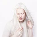 Albino female with white skin and white long hair. Photo face on a light background. Portrait of the head. Blonde girl Royalty Free Stock Photo