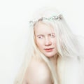 Albino female with wreath and white long hair. Photo face on a light background. Blonde girl Royalty Free Stock Photo