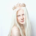 Albino girl with white skin, natural lips and white hair. Photo face on a light background. Portrait of the head. Blonde girl