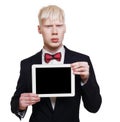 Albino young man in suit with laptop isolated.