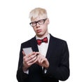 Albino young man in suit with mobile isolated.