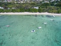 ALBION, MAURITIUS - DECEMBER 05, 2015: Beach in Mauritius with Yachts and Indian Ocean. Mountain and Palm Tree in background